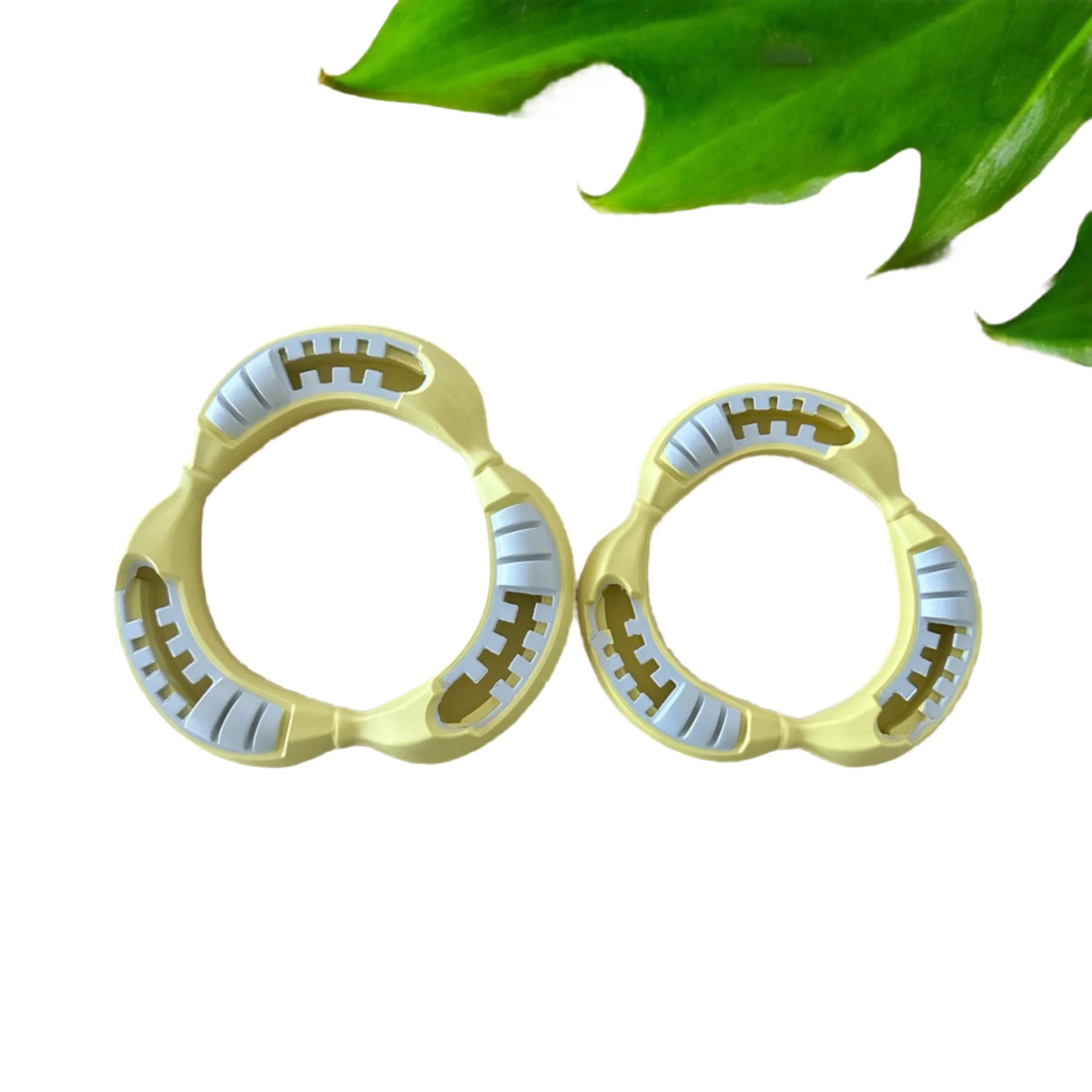 Two rubber Na Na Ring dog toys. Large and small in pale yellow.