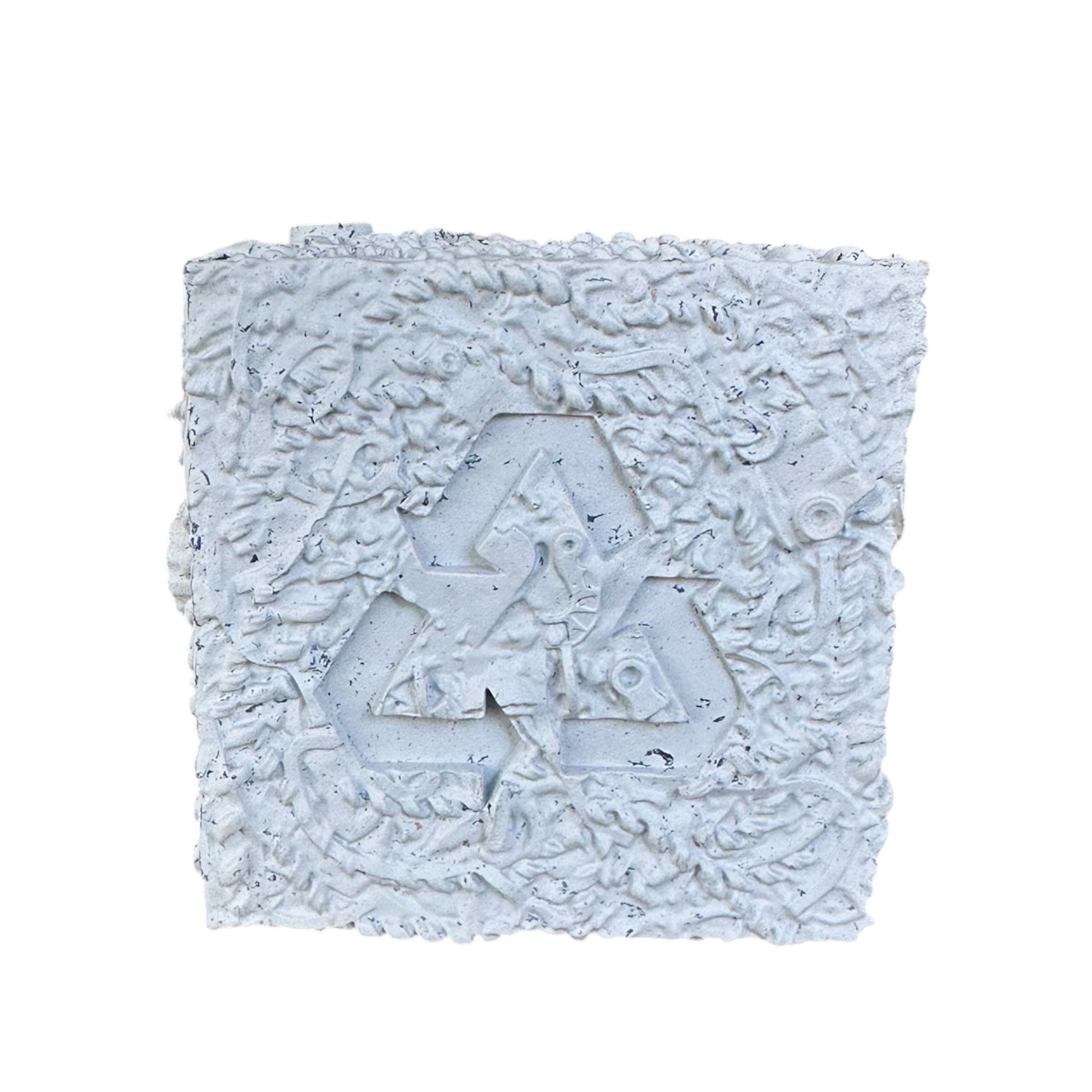 Grey rubber chew toy with recycle logo on it.