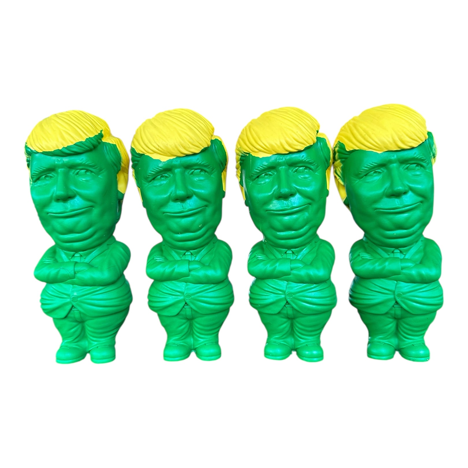 Four yellow and green rubber dog chew toys shaped like President Trump.